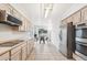 Bright kitchen with stainless steel appliances, light cabinetry, and adjacent dining area at 5129 Pasadena Way, Broomfield, CO 80023