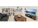 Comfortable living room with a view into the bedroom, featuring a TV, sofa, and shelving at 5129 Pasadena Way, Broomfield, CO 80023