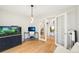 Open-concept living area with hardwood floors, aquarium, and a glimpse into an adjacent room at 5129 Pasadena Way, Broomfield, CO 80023
