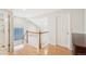 Upstairs hallway with hardwood floors, a glass block window, and access to rooms at 5129 Pasadena Way, Broomfield, CO 80023