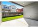View of the back patio with green grass, a wooden fence, and a view of the neighborhood at 6932 E 133Rd Ave, Thornton, CO 80602