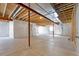 Unfinished basement with exposed ceiling, concrete flooring, and white-wrapped walls at 6932 E 133Rd Ave, Thornton, CO 80602