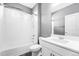 A well-lit bathroom features a shower-tub combo, neutral paint, and a modern vanity with ample storage at 6932 E 133Rd Ave, Thornton, CO 80602