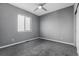 Cozy bedroom with neutral walls, plush carpet, ceiling fan and a bright window creating a comfortable retreat at 6932 E 133Rd Ave, Thornton, CO 80602