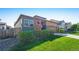 Charming exterior view of a home with lush green lawn and an American flag at 6932 E 133Rd Ave, Thornton, CO 80602