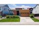 Inviting single-story home featuring a manicured lawn, brick accents, and a two-car garage at 6932 E 133Rd Ave, Thornton, CO 80602