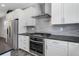 Modern kitchen features stainless steel appliances, white cabinets, and stylish backsplash for a sleek design at 6932 E 133Rd Ave, Thornton, CO 80602
