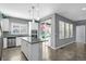 Bright kitchen with stainless steel appliances, island, and natural light from the sliding glass door at 6932 E 133Rd Ave, Thornton, CO 80602