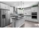 Modern kitchen features white cabinets, stainless steel appliances, and a center island at 6932 E 133Rd Ave, Thornton, CO 80602