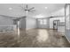 Open-concept living room featuring hardwood floors, recessed lighting, and modern ceiling fan at 6932 E 133Rd Ave, Thornton, CO 80602