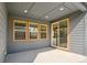 Covered patio with sliding glass door, recessed lights, and view to yard at 6932 E 133Rd Ave, Thornton, CO 80602