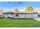 Lovely backyard with a well-maintained lawn, a concrete patio, and a stylish wooden pergola for outdoor enjoyment at 8236 W 71St Pl, Arvada, CO 80004