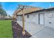 Backyard featuring a concrete patio covered by a pergola and mulched landscape surrounding a green, grassy area at 8236 W 71St Pl, Arvada, CO 80004
