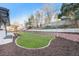 The backyard shows an expansive lawn with tiered landscaping and is enclosed by a tall wooden fence for privacy at 8236 W 71St Pl, Arvada, CO 80004