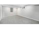 Finished basement with neutral carpet, white walls and two windows for lots of natural light at 8236 W 71St Pl, Arvada, CO 80004