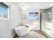 Spa-like bathroom featuring a soaking tub, a frameless glass shower, and modern fixtures at 8236 W 71St Pl, Arvada, CO 80004