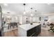 Open-concept kitchen seamlessly connects to the dining and living areas, ideal for entertaining at 8236 W 71St Pl, Arvada, CO 80004