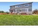 Backyard with covered patio, hot tub, chairs and lawn at 8522 S Dudley St, Littleton, CO 80128