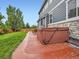 Backyard patio with hot tub, lawn, and mature trees at 8522 S Dudley St, Littleton, CO 80128