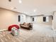 Finished basement with large open floorplan and carpeted floors at 8522 S Dudley St, Littleton, CO 80128