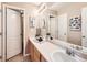 Bathroom with double vanity and decorative lighting fixtures at 8522 S Dudley St, Littleton, CO 80128