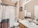 Bright bathroom with a shower and bathtub combo with coordinating vanity and décor at 8522 S Dudley St, Littleton, CO 80128