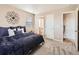 Comfortable bedroom with access to bathroom and hallway at 8522 S Dudley St, Littleton, CO 80128