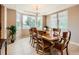 Spacious dining room featuring large windows, tiled floors, and ample natural light at 8522 S Dudley St, Littleton, CO 80128