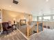 Hallway with stairs and railing, showing access to upper floor and bedrooms at 8522 S Dudley St, Littleton, CO 80128