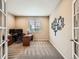 Bright home office with desk, large window, and neutral decor at 8522 S Dudley St, Littleton, CO 80128