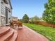 Back patio with comfortable seating, lawn, and mature trees at 8522 S Dudley St, Littleton, CO 80128