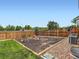 Fenced in backyard with playground and grass at 8522 S Dudley St, Littleton, CO 80128