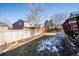 Wide backyard with a deck, lawn, and privacy fence, creating a perfect space for outdoor activities at 1099 Thornbury Pl, Highlands Ranch, CO 80129