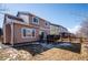 Back exterior of the home with deck and fenced yard, offering a private and inviting outdoor space at 1099 Thornbury Pl, Highlands Ranch, CO 80129