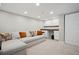 Cozy basement living room with a comfortable couch and built-in desk area, perfect for relaxation and productivity at 1099 Thornbury Pl, Highlands Ranch, CO 80129