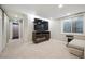 Inviting basement living room with a large screen television and electric fireplace, offering entertainment and warmth at 1099 Thornbury Pl, Highlands Ranch, CO 80129