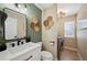 Stylish bathroom with modern vanity, mirror, and combined laundry area at 1099 Thornbury Pl, Highlands Ranch, CO 80129