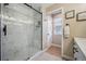 Bright bathroom showcasing a modern glass-enclosed shower with marble tile and stylish fixtures at 1099 Thornbury Pl, Highlands Ranch, CO 80129