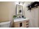 Modern bathroom with wood vanity, a sleek mirror, and stylish fixtures, creating a spa-like experience at 1099 Thornbury Pl, Highlands Ranch, CO 80129