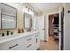 Elegant bathroom with a double sink vanity, modern fixtures, and access to a walk-in closet at 1099 Thornbury Pl, Highlands Ranch, CO 80129