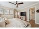 Bright bedroom with a ceiling fan, modern decor, and a comfortable bed with soft bedding at 1099 Thornbury Pl, Highlands Ranch, CO 80129
