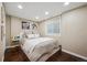 Comfortable bedroom featuring dark wood floors, a plush bed, and a window for natural light, creating a cozy retreat at 1099 Thornbury Pl, Highlands Ranch, CO 80129