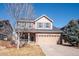 Charming two-story home featuring a well-manicured lawn, a two-car garage, and a welcoming front porch at 1099 Thornbury Pl, Highlands Ranch, CO 80129