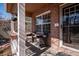 Cozy front porch with brick accents, seating area, and natural light, perfect for enjoying quiet moments at 1099 Thornbury Pl, Highlands Ranch, CO 80129