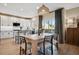 Eat-in kitchen featuring stainless steel appliances, white cabinetry, and hardwood floors at 1099 Thornbury Pl, Highlands Ranch, CO 80129