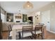 Open-concept living and dining area with hardwood floors and a fireplace at 1099 Thornbury Pl, Highlands Ranch, CO 80129