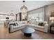 Bright and spacious living room with large windows and a comfortable seating area at 1099 Thornbury Pl, Highlands Ranch, CO 80129