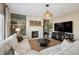 Inviting living room featuring a stone fireplace and neutral decor at 1099 Thornbury Pl, Highlands Ranch, CO 80129