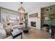 Cozy living room with a stone fireplace and lots of natural light at 1099 Thornbury Pl, Highlands Ranch, CO 80129