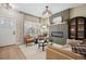 Bright living room featuring modern furnishings, a decorative fireplace, and natural light from the large windows at 1099 Thornbury Pl, Highlands Ranch, CO 80129